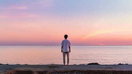Embracing the Dawn: A Lone Figure Reflects on the New Year with a Gentle Pink Sunrise