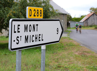 Road sign with arrow and directions to the Mont Saint Michel Abbey in France © ChiccoDodiFC