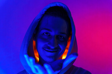 Cool man. Fashionable portrait. Colorful neon light. Stylish confident handsome male in trendy