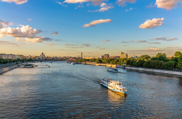 Naklejka premium Cruise ship sails on the Moscow river in Moscow city center, popular place for walking.
