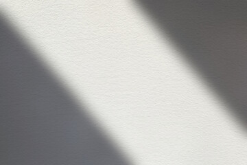 White Stucco Wall with Shadow and Light Beam on Surface, Suitable for Making Blur to multiply and overlay on Product Presentation.