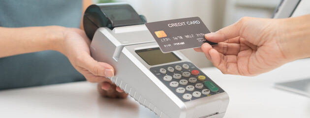 Pay, cashless technology concept, customer using credit card to buy at counter cashier, holding...