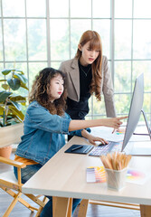 Asian professional successful young female creative graphic designer in casual outfit sitting...