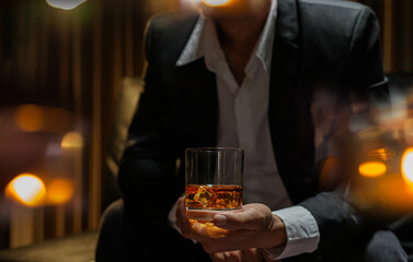 businessmen holding a glass of whiskey