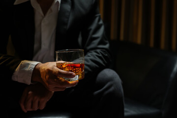 businessmen holding a glass of whiskey