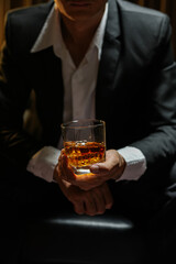 businessmen holding a glass of whiskey