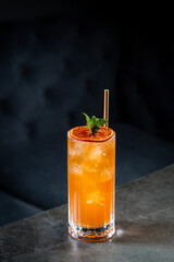 tropical cocktail with sunset gradient and citrus side view