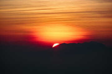 Fiery Dawn: Bromo's Sunrise Paints the Sky in Red and Gold