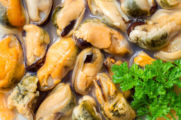 Mussels with greens. Marinated mussels in brine. Mussel meat. Seafood close-up.