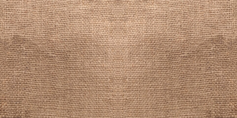 Top view of natural brown hessian cloth or gunny sack. Hessian cloth is an inexpensive fabric or garment made of hessian or burlap formed of jute, coarsely woven fabric. Sackcloth textured background