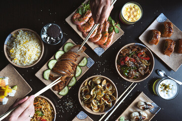 Couple eating with chopsticks at Japanese restaurant table