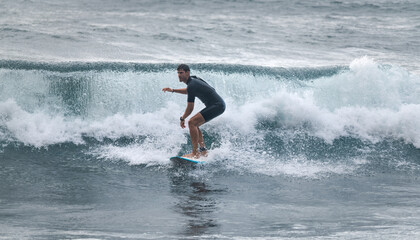 Surfer riding on a broken wave