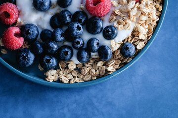 Overhead shot of yogurt bowl with berries and granola.