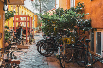 bicycle parking in the courtyard of house on old street of Copenhagen - obrazy, fototapety, plakaty