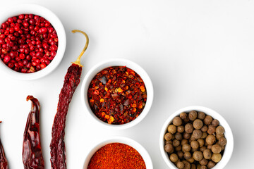 Various spices in a bowls on white background