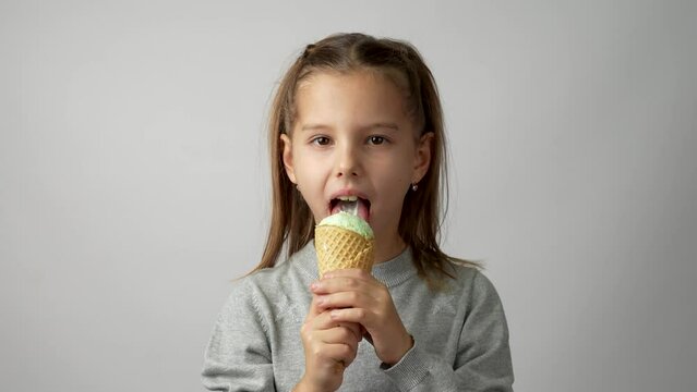 Cute little girl enjoys a delicious ice cream cone