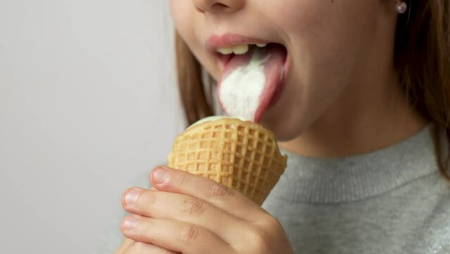Cute little girl enjoys a delicious ice cream cone