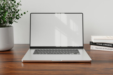 Fototapeta premium Laptop with blank white screen on wood table with modern workplace background
