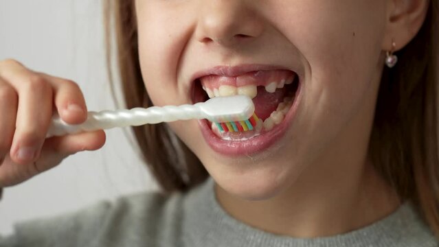 Child brushing teeth with smile, white background