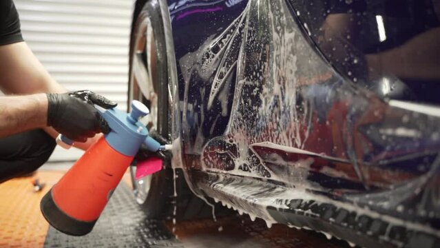 Installation of a protective paint and varnish transparent film on the car. PPF polyurethane film to protect the car paint from stones and scratches. Car detailing. 