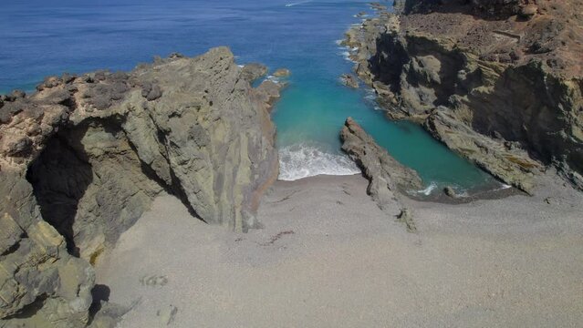 Fuerteventura Island: aerial view over Jurado beach and its famous arch (Horadada). On a sunny day with beautiful colors.