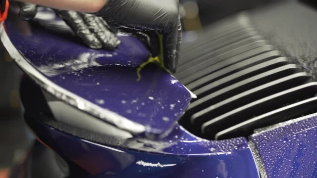 Installation of a protective paint and varnish transparent film on the car. PPF polyurethane film to protect the car paint from stones and scratches. Car detailing. 