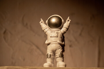Plastic toy figure astronaut on moon concrete background Copy space. Concept of out of earth travel, private spaceman commercial flights. Space missions and Sustainability
