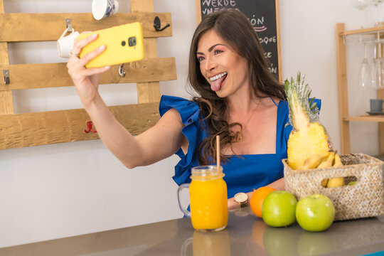 Woman taking a selfie showing healthy juice and fruit