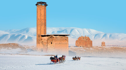 Horses pulling sleigh in winter - Ani Ruins, Ani is a ruined and  medieval Armenian city - Kars,...