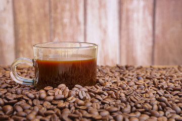Coffee cup and coffee beans on a wooden table