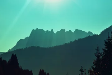 Gordijnen Silhouette of mountains. Mountain landscape in the evening. The Dolomites Alps against the sunset sky. Sella Pass, Grohmannspitze, Selva di Val Gardena, Bolzano, Italy © vvvita