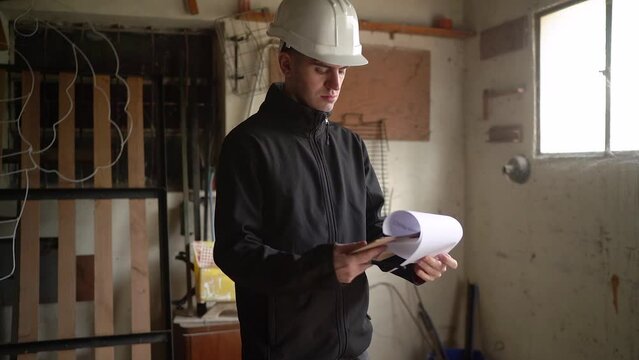 Home Renovation - Young Structural Inspector Reviewing Details For House Renovation. zoom-in