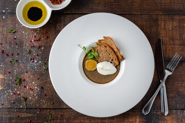 Crostini Fegatini on white porcelain plate on wooden table