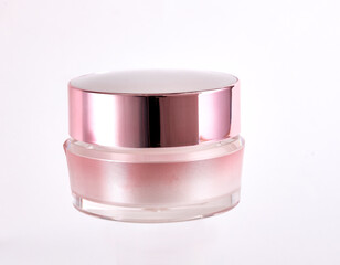 Pink color cosmetic jar containing moisturizing cream, isolated on white background