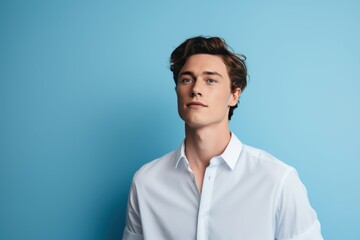 Attractive young caucasian man on blue wall. Stylish macho guy in white shirt. Generate Ai - obrazy, fototapety, plakaty
