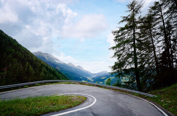Asphalt road in Alp mountains. Road trip concept. Beautiful landscape.