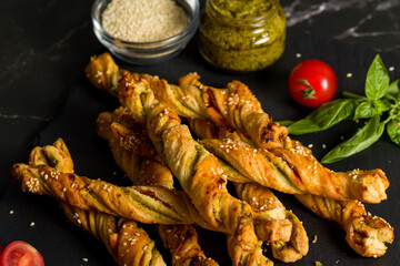 Bread sticks with sesame and tomato with pesto sauce
