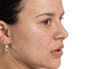 Profile portrait of a natural woman, without makeup, highlighting her unadorned beauty and authenticity on white background
