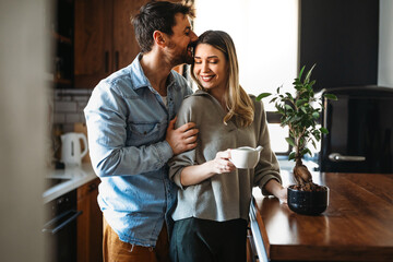 Loving everything about her. Smiling environmentally friendly couple with houseplant