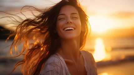 Foto op Aluminium Portrait of calm happy smiling free woman with open arms and closed eyes enjoys a beautiful moment life on the seashore at sunset time © LaxmiOwl