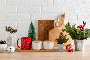Stylish Christmas decor in the Christmas kitchen. Beautiful kitchen utensils decorated with green...