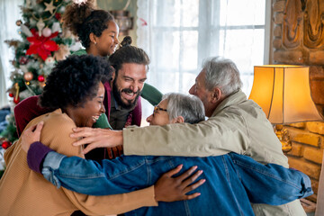 Cheerful extended multiethnic family having fun while celebrating Christmas together at home.
