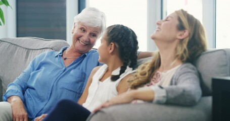 Family, love and generations of funny women on a sofa in the living room of their home together. Grandma, mother and daughter laughing in an apartment to visit her grandparent during retirement