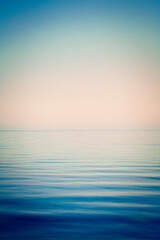 Background of sky and sea, sea is very calm with gentle ripples, with an instagram effect.