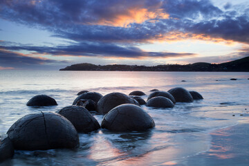 New Zealand, a landmark on the east coast of the South Island, Moeraki Boulders seen under a...