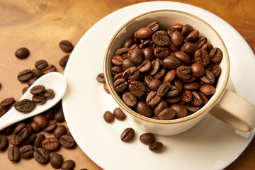 Black coffee and coffee beans on Wooden table
