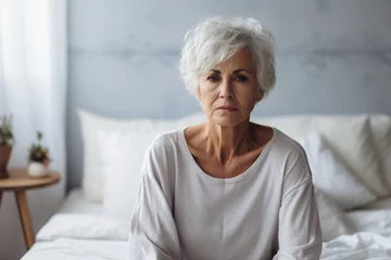 Foto op Plexiglas Caucasian mature woman frustrating while sit alone on bed in bedroom, Attractive old female upset depressed feel infuriating, sad and upset with life problem in house, Health care Medical Concept © alisaaa