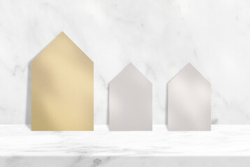 Old Paper Houses on Marble Table with White Wall Background with Tree Shadow, Suitable for Product Presentation Backdrop, Display, and Mock up.