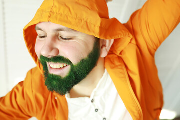 A man with a green beard. St.Patrick 's Day. Irish fan color beard.