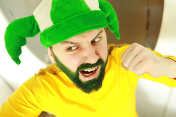 A man with a green beard. St.Patrick 's Day. Irish fan color beard.